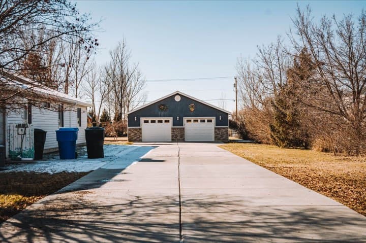 A detached two-car garage at the end of a driveway